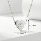 Silver heart-shaped necklace with engraved letter 'B' on a light gray background